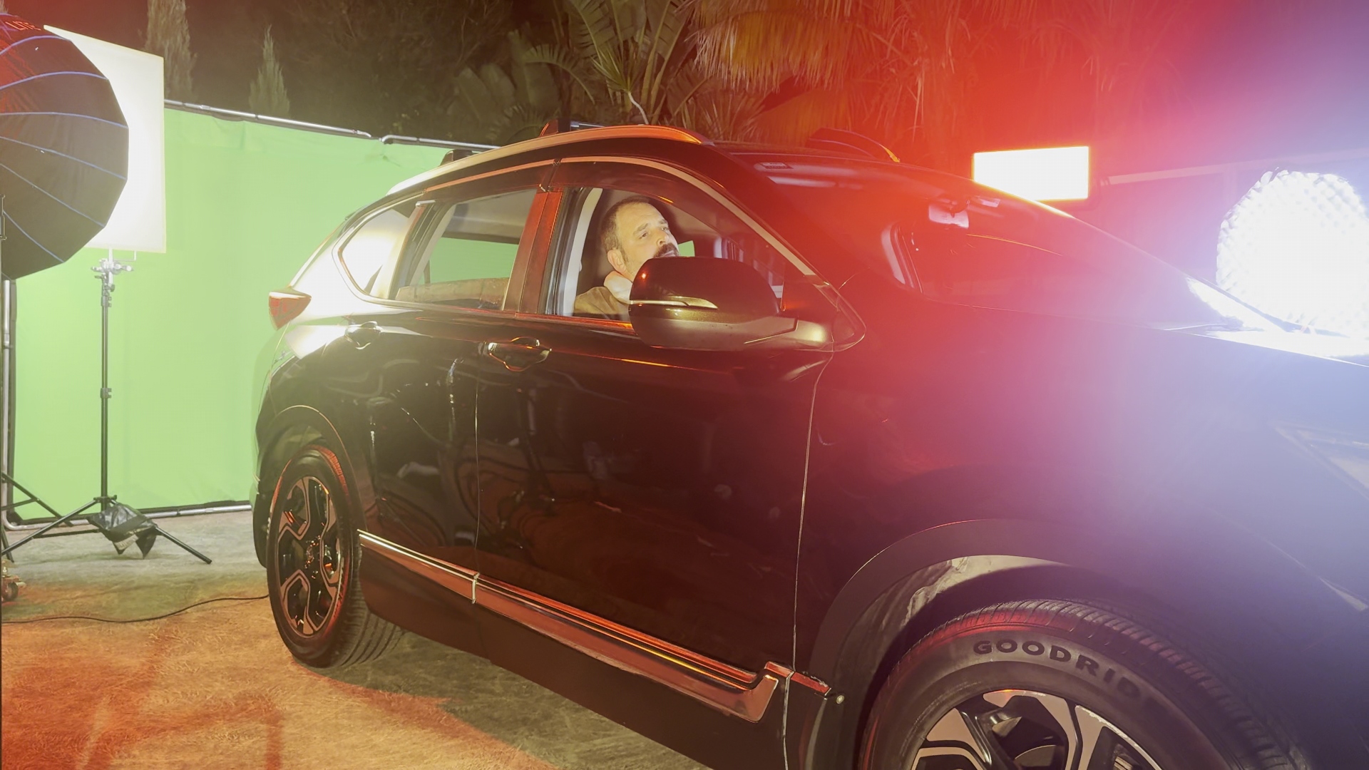 Car from side with green screen and practical lights