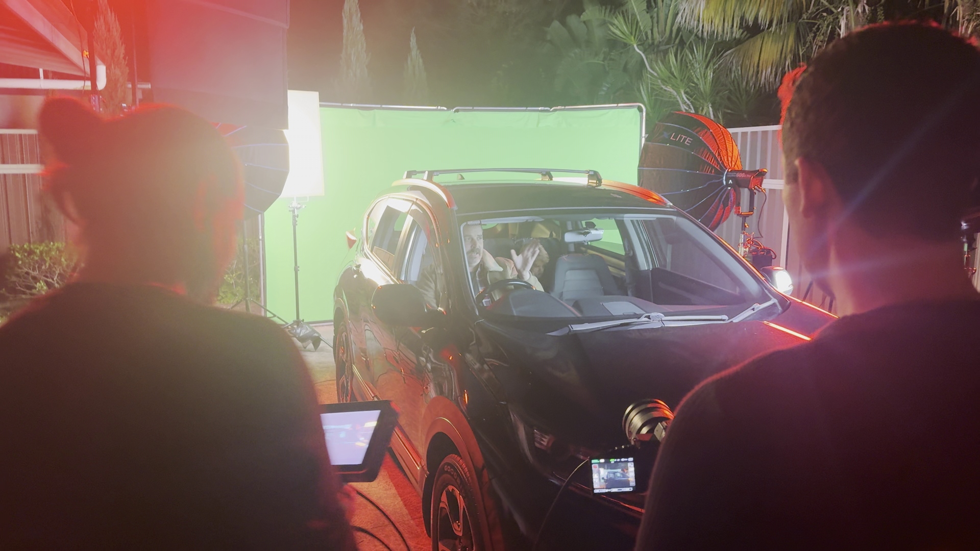 Child actor in backseat with iPad between takes