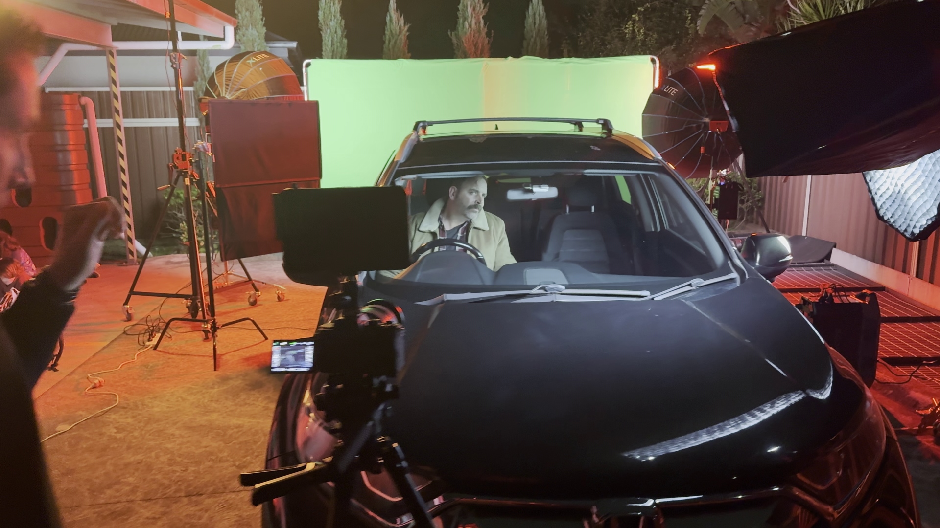 Car on green screen stage, front view with camera rig